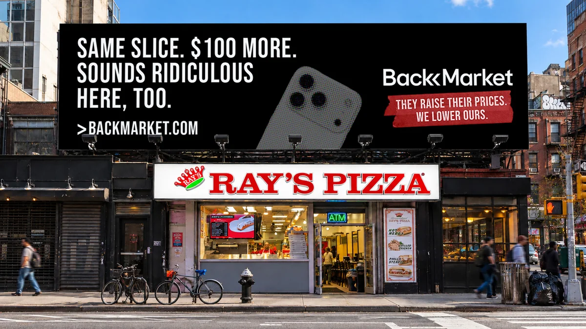 Billboard above a pizza shop: “Same slice. $100 more. Sounds ridiculous here, too.” with the Back Market logo